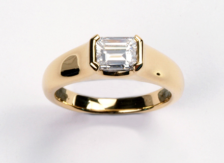 A 18ct Fairtrade yellow gold endset ring set with a 1.07ct emerald cut diamond