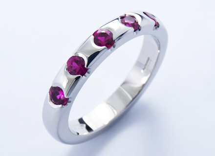Eternity style platinum ring end set with round brilliant cut rubies 