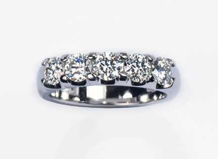 Eternity style platinum ring claw-set with round Brilliant cut diamonds