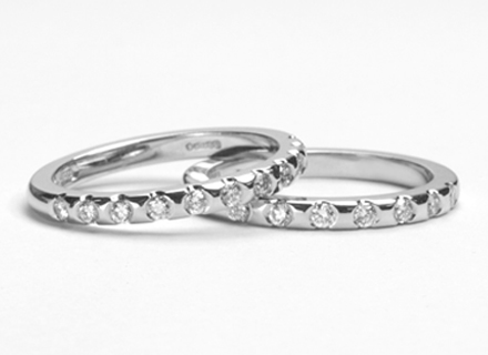 Eternity style platinum rings end set with round brilliant cut diamonds