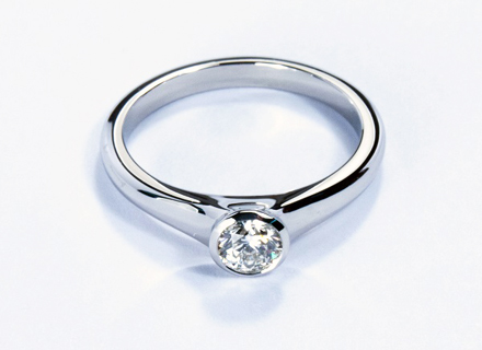 Platinum Sculptured Sweep ring set with a round brilliant cut diamond