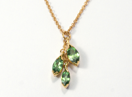 Floral yellow gold pendant with marquise cut tsavorites